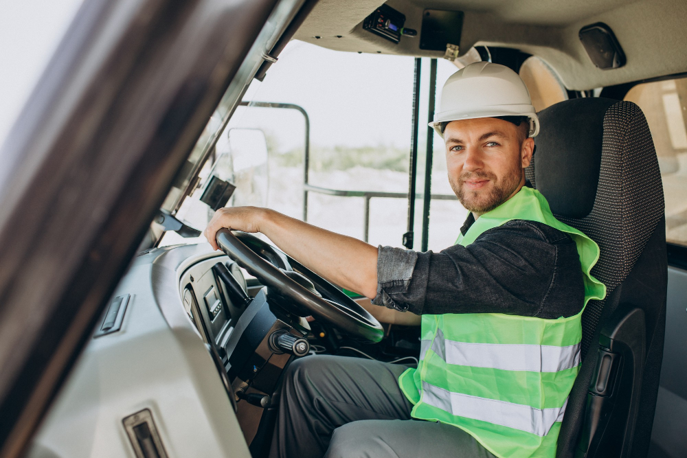 male worker with bulldozer sand quarry